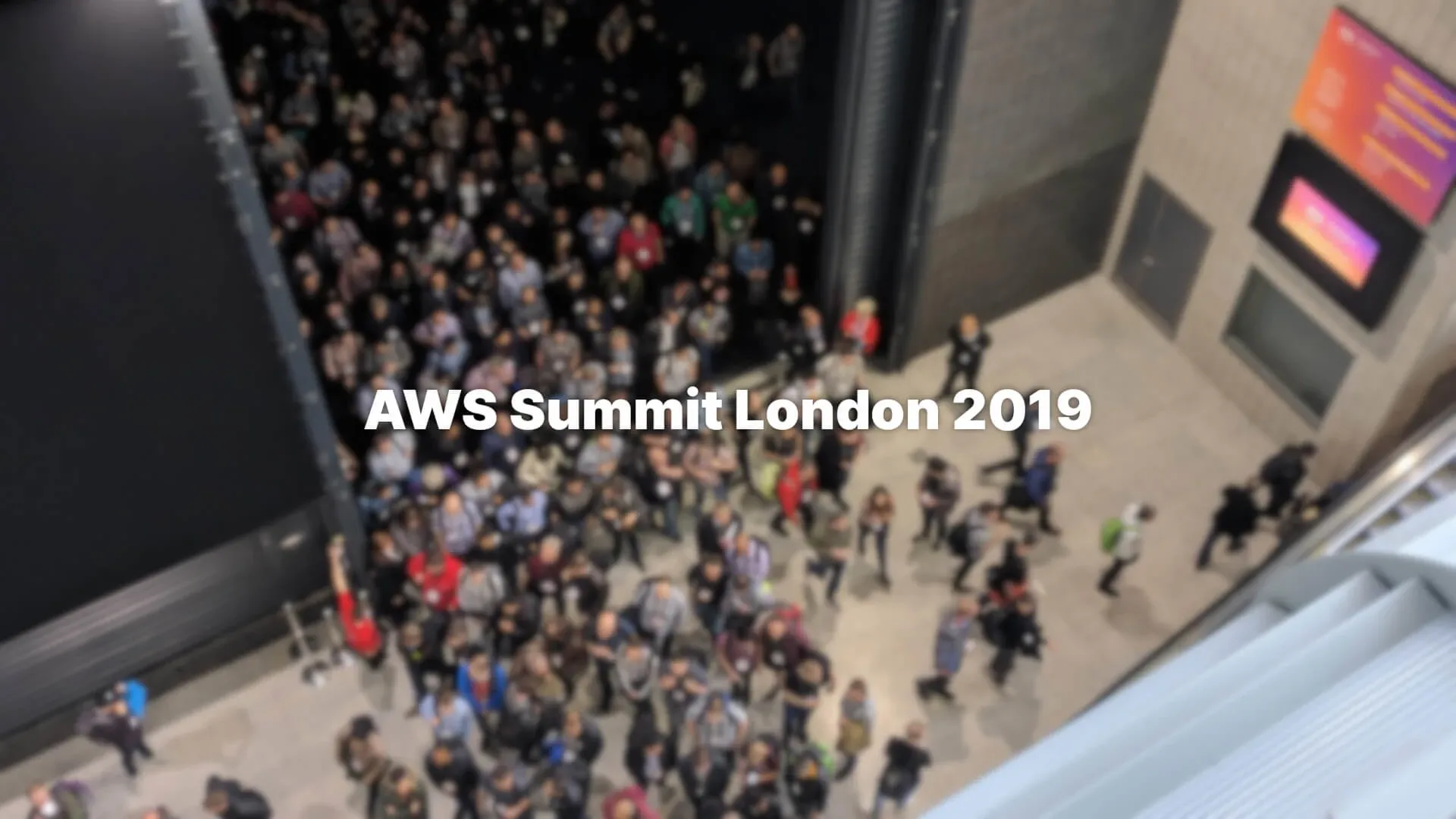 Overhead shot of a large number of people leaving a theatre at the AWS Summit